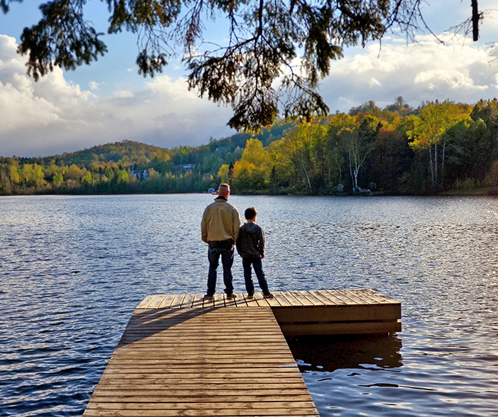 People on dock looking at lake